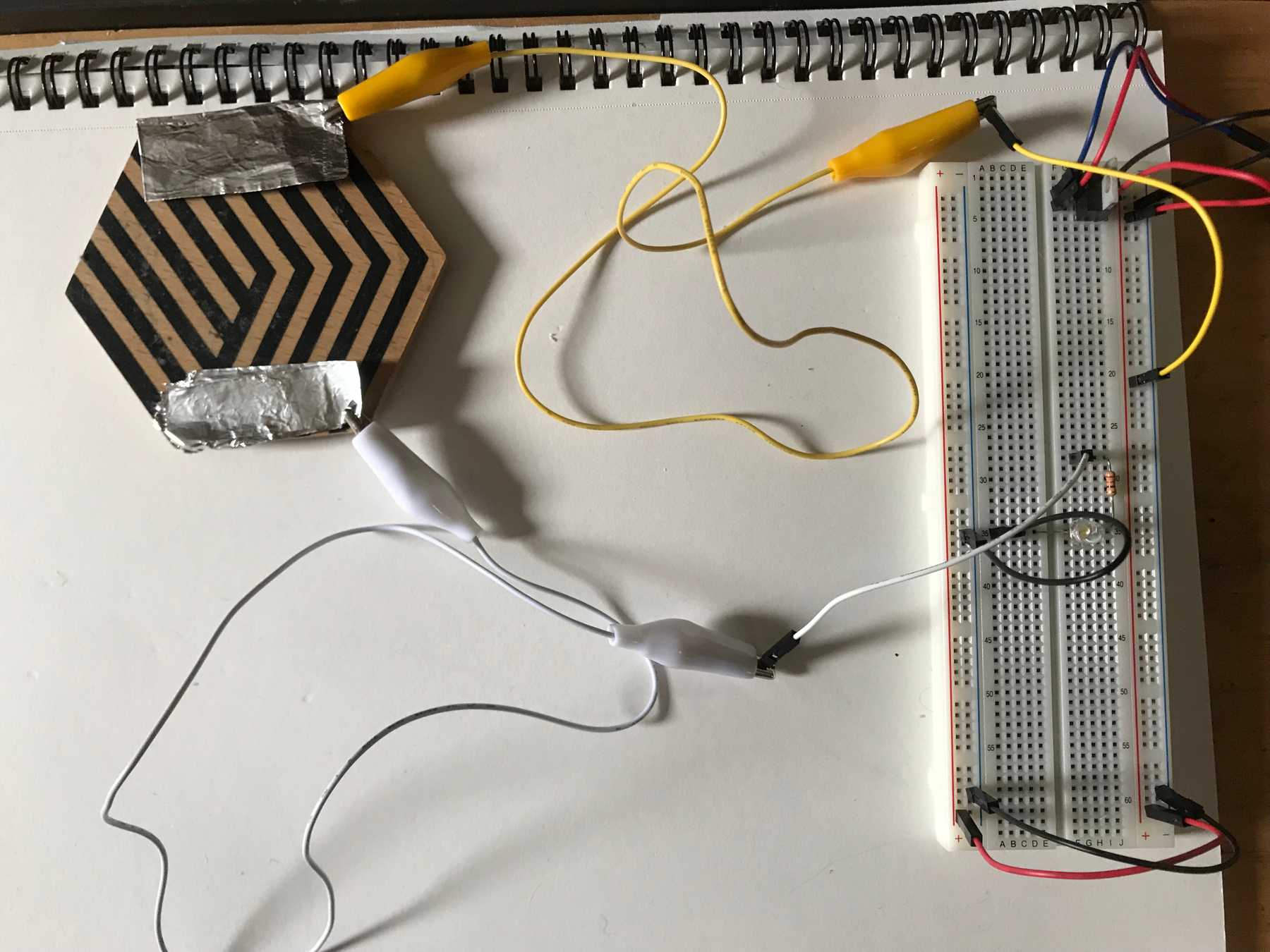 Wiring the coaster switch to the breadboard by connecting one side to Vin and the other to the resistor's input
