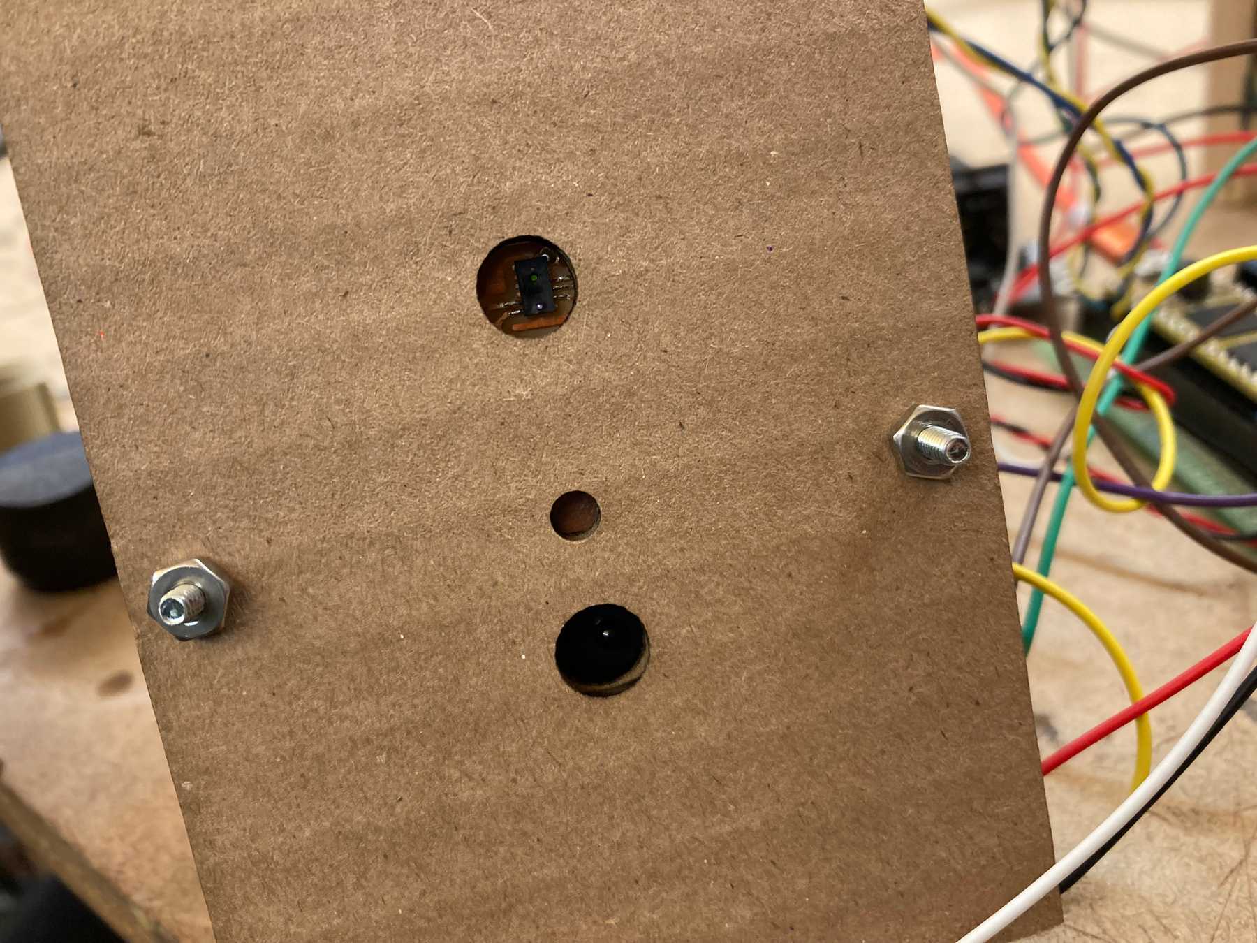 The distance sensor aligns with the hole