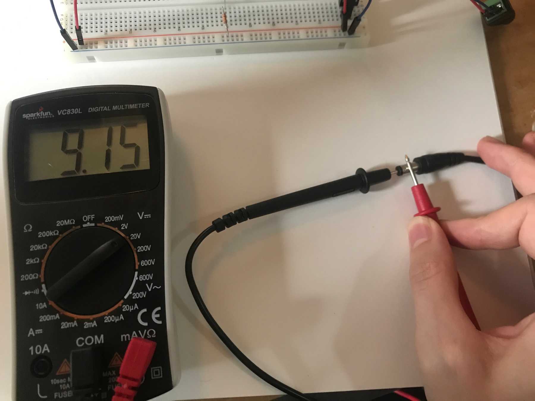 DC Voltage Measurement showing 9.15V with ground connected to the inner part of the jack
