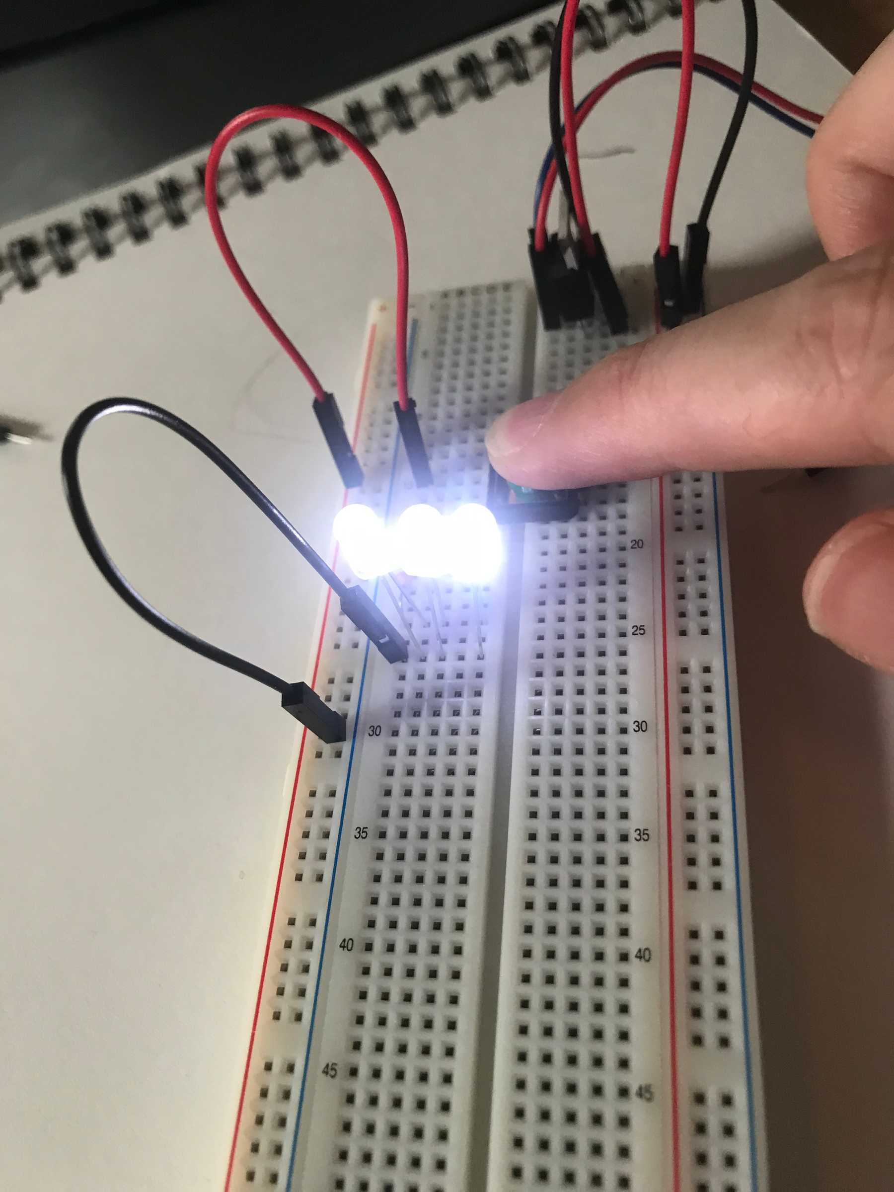 Three LEDs in parallel illuminate when the button is pressed