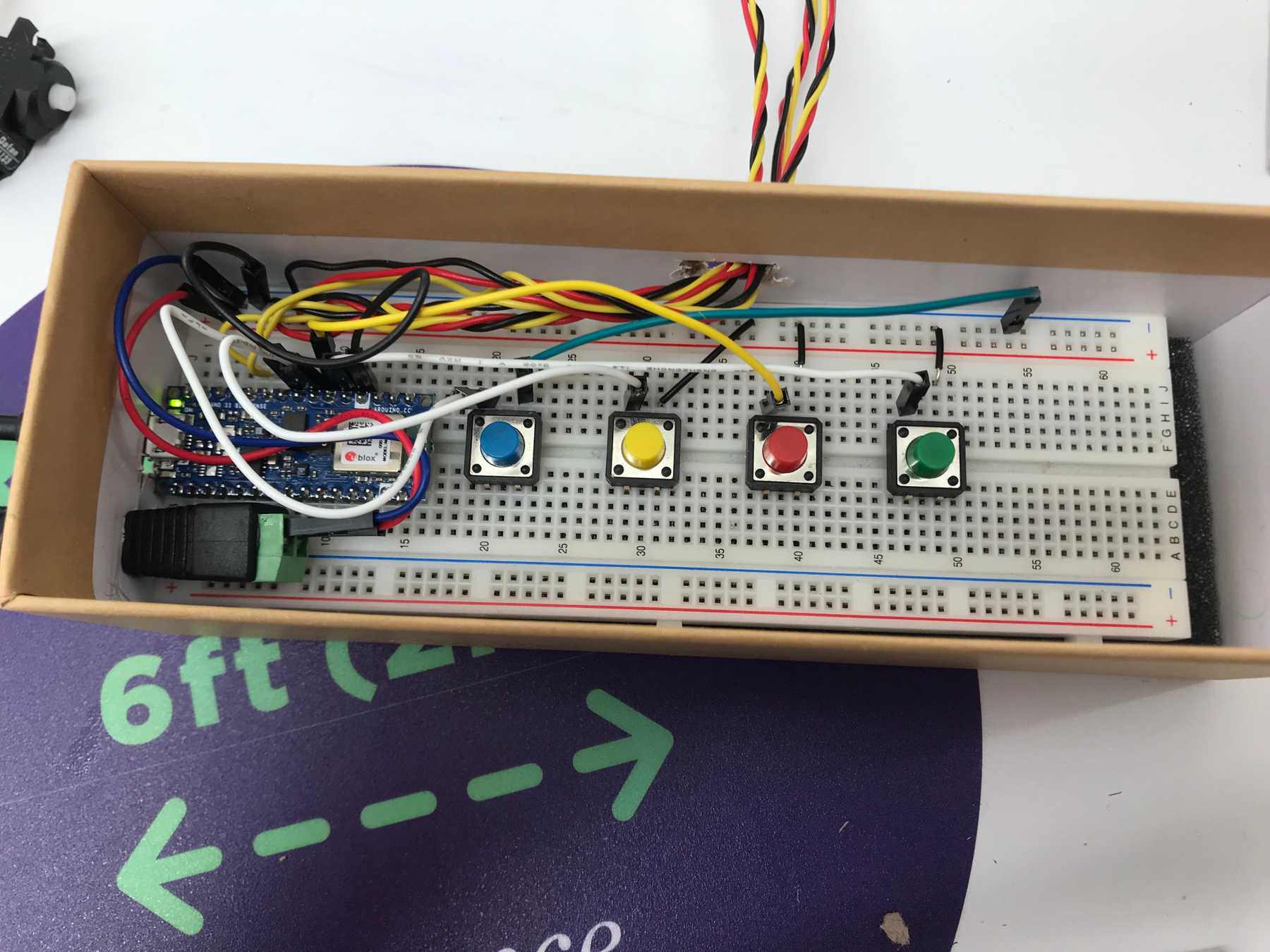 The wiring: four pushbuttons and three servo motors connected to an Arduino nano